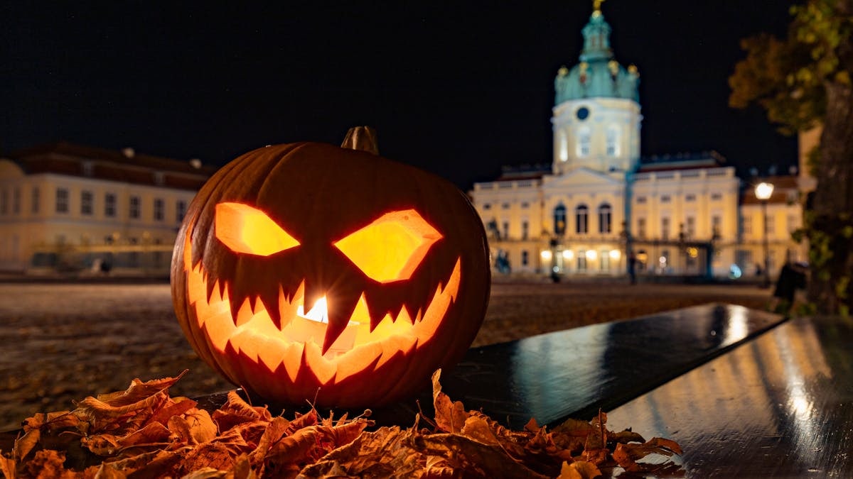 Glowing Jack-o'-Lantern in front of Charlottenburg Palace illuminates the night.